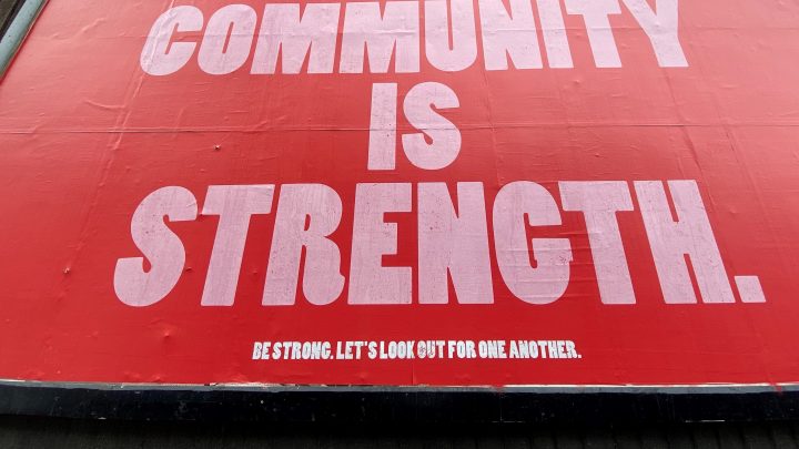 billboard sign: Community is Strength by john cameron from unsplash