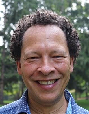 A photo of author Lawrence Hill smiling.