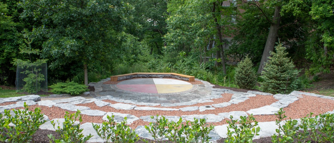 trees surround colour stones in shape of a circle